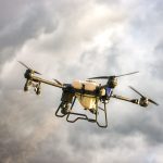 Illustrative photograph: High-tech drone flying amidst dramatic cloudy skies, showcasing advanced technology.